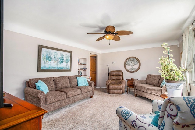 carpeted living area featuring a ceiling fan