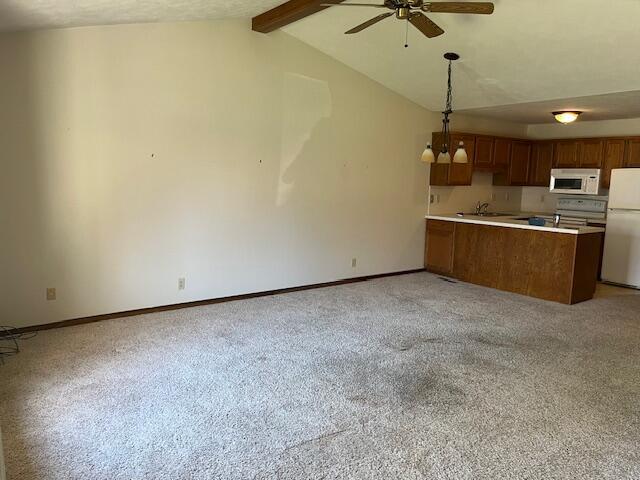 kitchen featuring ceiling fan, light colored carpet, brown cabinets, baseboards, and white appliances