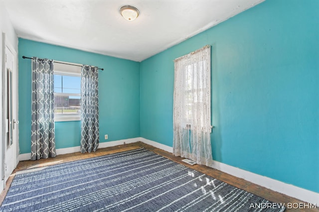 empty room with baseboards and visible vents