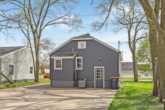 back of property featuring central AC