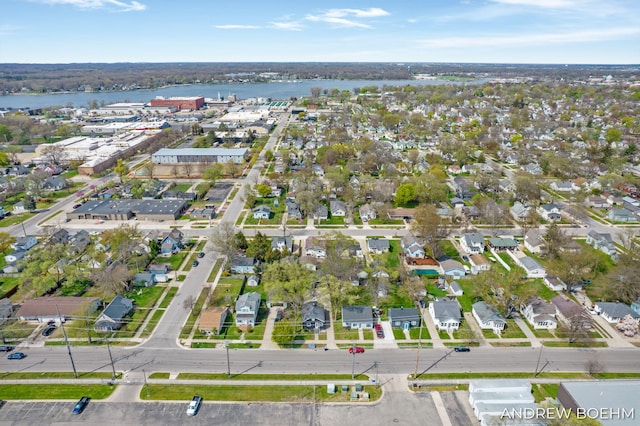 birds eye view of property with a water view and a residential view