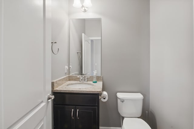 half bathroom with vanity and toilet