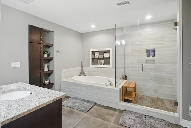 full bathroom with visible vents, tile patterned flooring, vanity, a garden tub, and a shower stall