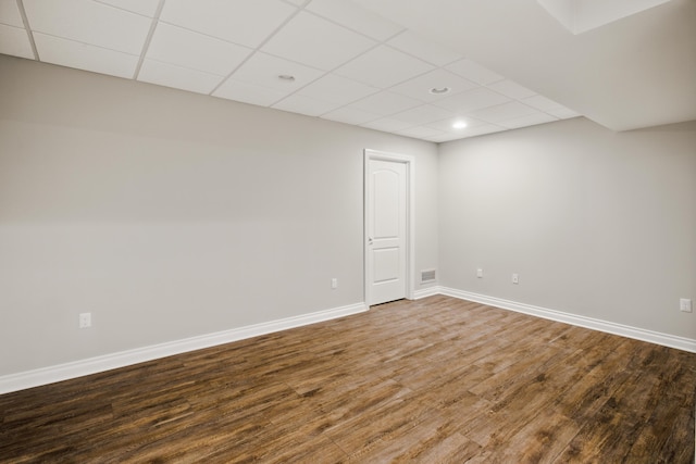 unfurnished room featuring visible vents, a paneled ceiling, wood finished floors, baseboards, and recessed lighting