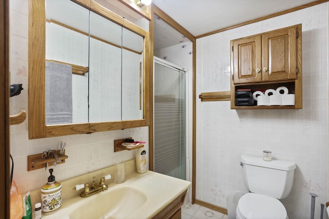 bathroom with vanity, a stall shower, toilet, and tile walls
