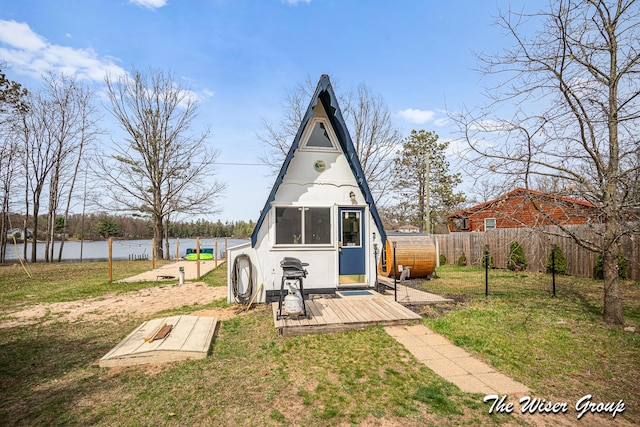 view of shed featuring a water view and a fenced backyard