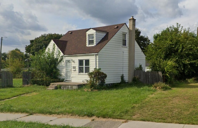 view of front of house featuring fence, a chimney, and a front yard