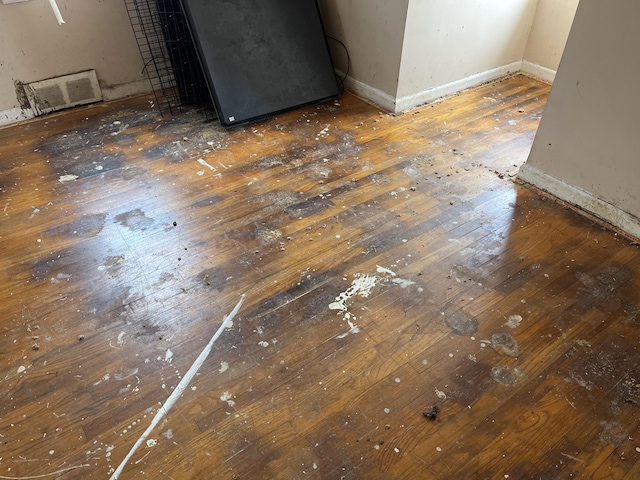 interior details featuring baseboards and wood finished floors