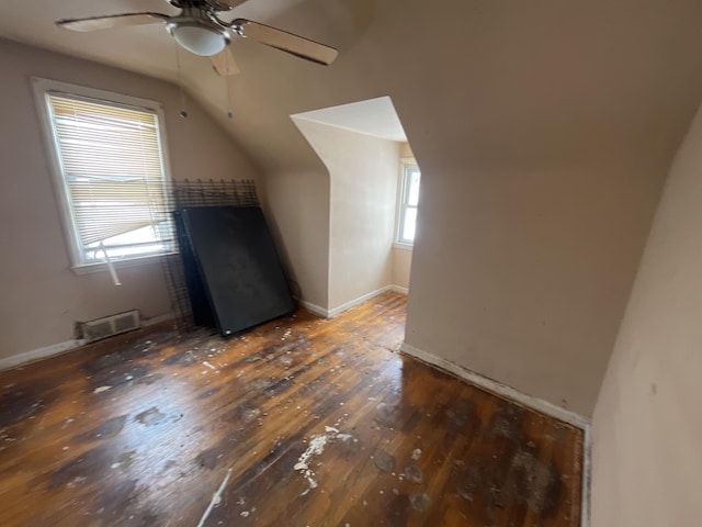 bonus room featuring a ceiling fan, baseboards, lofted ceiling, visible vents, and hardwood / wood-style flooring