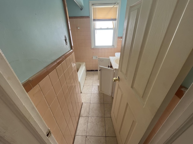 full bath featuring wainscoting, tile walls, vanity, and tile patterned floors
