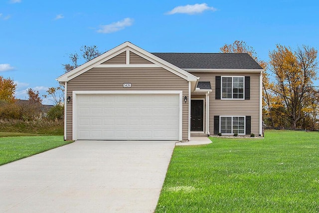 view of front facade with a garage, driveway, and a front lawn