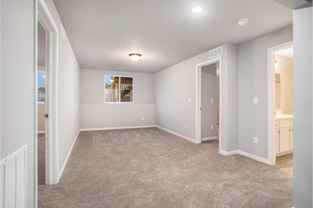 unfurnished room with carpet floors, baseboards, and visible vents