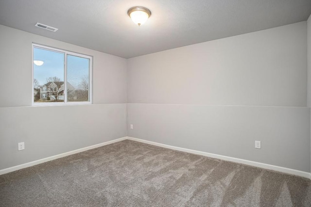 empty room featuring baseboards, carpet, and visible vents