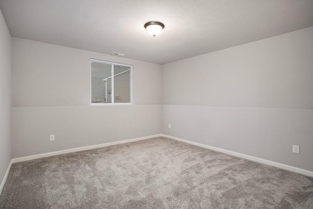 unfurnished room featuring carpet floors, baseboards, and visible vents