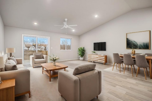 living room with baseboards, light wood finished floors, ceiling fan, and lofted ceiling