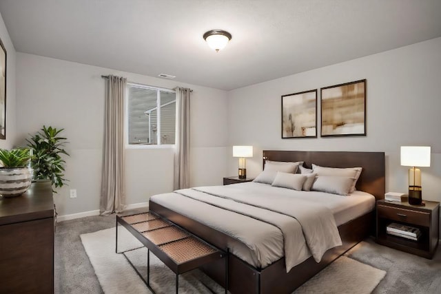bedroom with baseboards, carpet flooring, and visible vents
