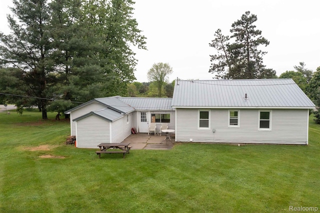 968 N Wilder Rd, Lapeer, MI 48446 - rear view of house featuring a patio area, a yard, and metal roof