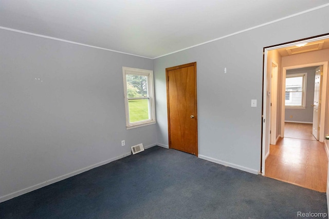 968 N Wilder Rd, Lapeer, MI 48446 - unfurnished bedroom with multiple windows, baseboards, and a closet
