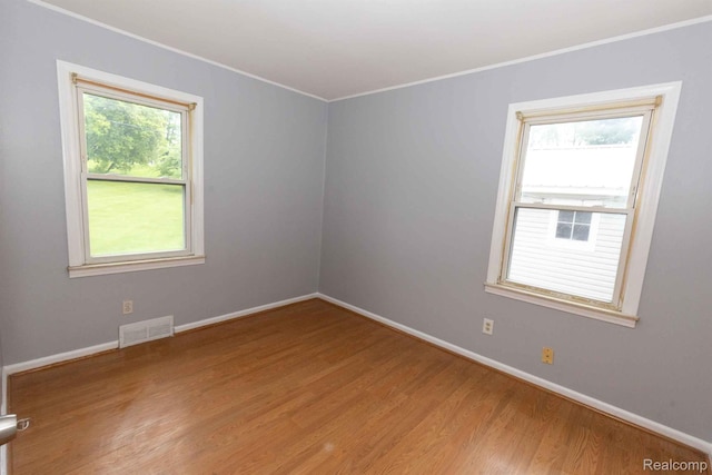 968 N Wilder Rd, Lapeer, MI 48446 - unfurnished room featuring ornamental molding, light wood-style flooring, and baseboards