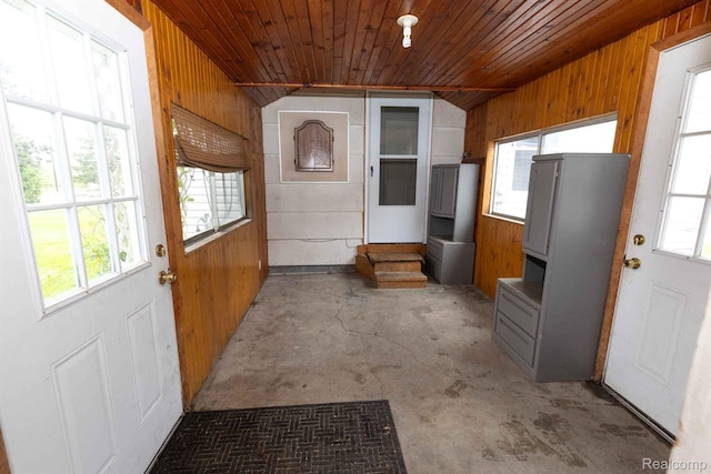 968 N Wilder Rd, Lapeer, MI 48446 - doorway to outside with wooden walls, wood ceiling, and concrete floors