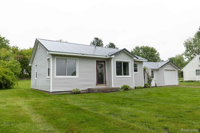968 N Wilder Rd, Lapeer, MI 48446 - ranch-style home featuring a front yard, metal roof, and a detached garage