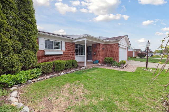 ranch-style home featuring brick siding, driveway, a front yard, and a garage