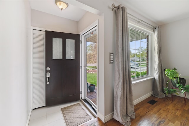 entrance foyer featuring baseboards, visible vents, and light wood-style flooring