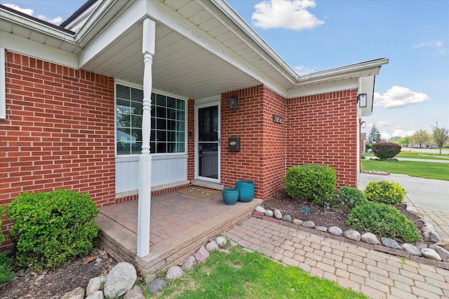 entrance to property featuring brick siding