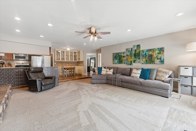 living room with ceiling fan, light carpet, and recessed lighting