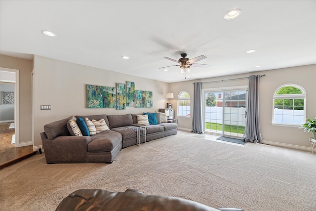 carpeted living room with recessed lighting and baseboards