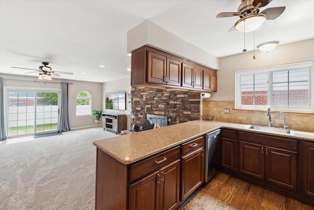 kitchen with stainless steel dishwasher, ceiling fan, a sink, and tasteful backsplash