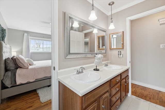 full bath featuring a sink, crown molding, double vanity, and connected bathroom