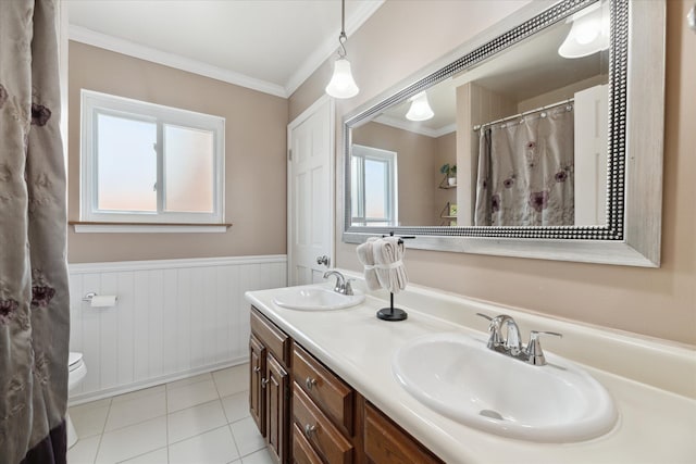full bath with crown molding, a sink, a wainscoted wall, and tile patterned flooring