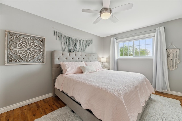 bedroom featuring a ceiling fan, baseboards, and wood finished floors