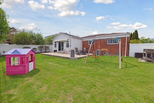 rear view of property with a fenced backyard, cooling unit, a patio area, and brick siding
