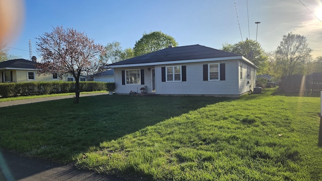 bungalow-style home with a front yard