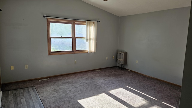 unfurnished room with baseboards, carpet flooring, heating unit, and lofted ceiling