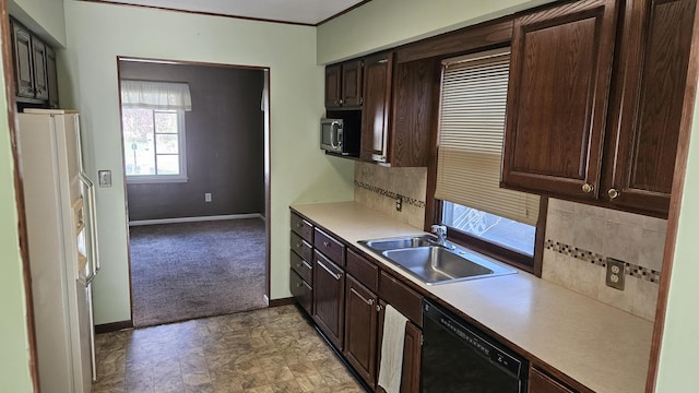 kitchen with dark brown cabinetry, dishwasher, a sink, freestanding refrigerator, and stainless steel microwave