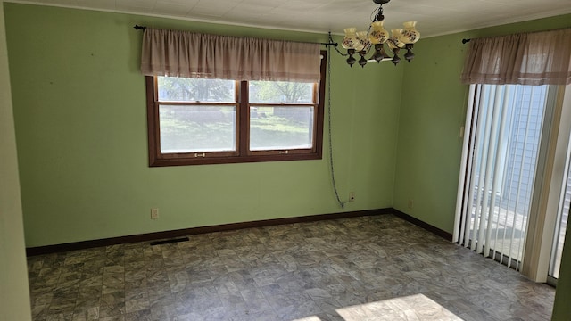 unfurnished room featuring an inviting chandelier, baseboards, visible vents, and stone finish floor