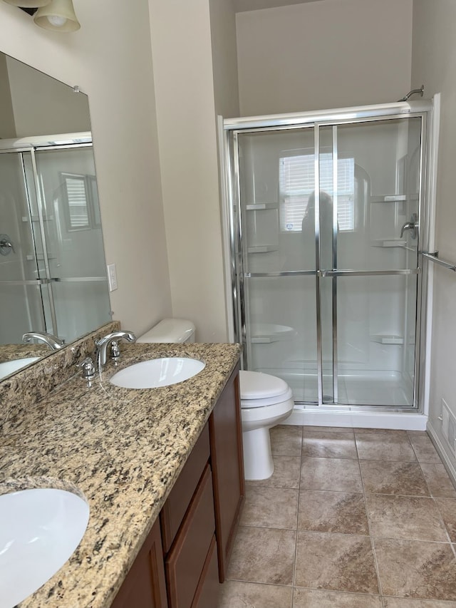 1082 Paddock Dr Unit 78, South Lyon, MI 48178 - bathroom featuring double vanity, toilet, a sink, and a stall shower