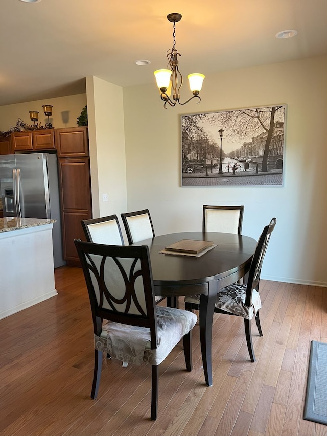 1082 Paddock Dr Unit 78, South Lyon, MI 48178 - dining room featuring light wood-style floors, baseboards, and a notable chandelier