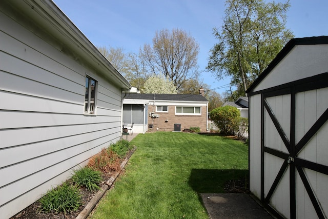 view of yard featuring a storage shed and an outbuilding