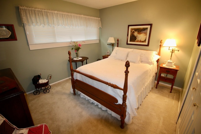 carpeted bedroom with baseboards