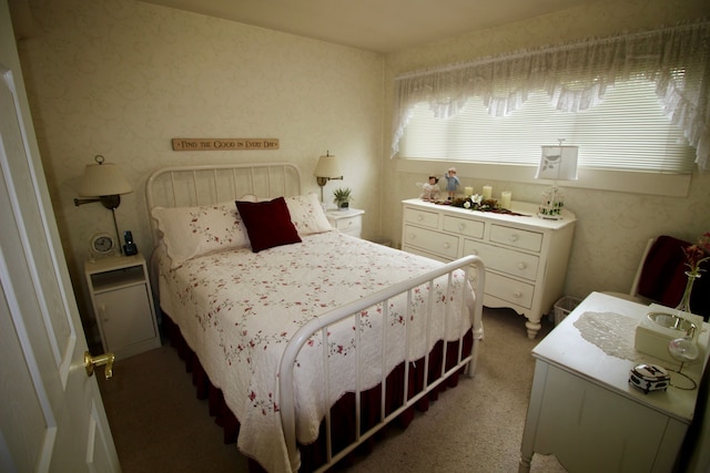 carpeted bedroom with wallpapered walls