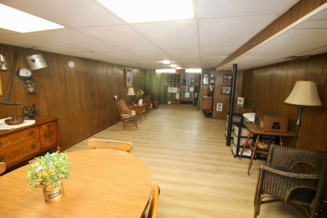 interior space featuring wood walls, a paneled ceiling, and wood finished floors