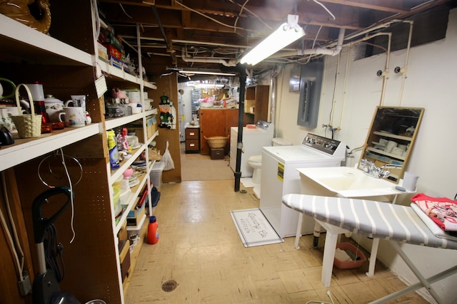 unfinished basement with light floors and washing machine and clothes dryer