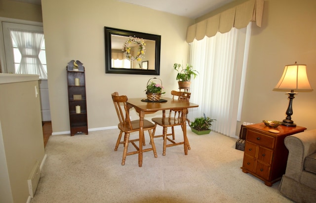 dining space featuring carpet floors and baseboards