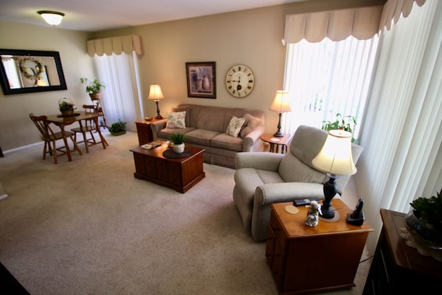 carpeted living area featuring baseboards