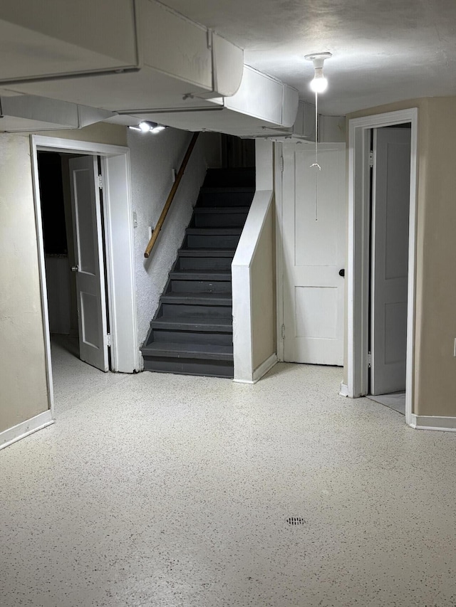 finished below grade area with baseboards and stairs