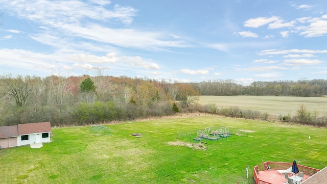 view of yard featuring a fire pit and an outdoor structure